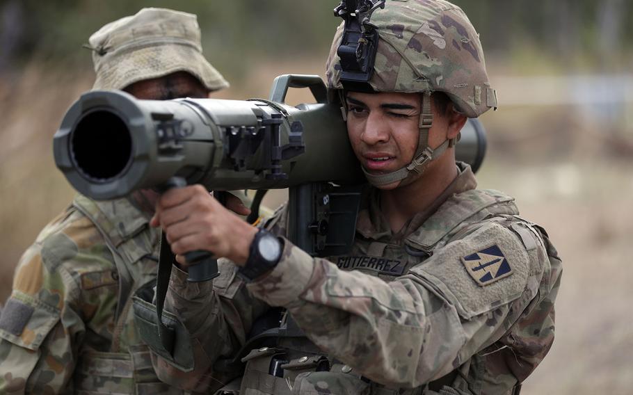 Australian Army Pvt. James Gale explains the operation of the M4 84 mm Carl Gustav recoilless rifle to U.S. Pfc. William Gutierrez, an Indiana National Guardsman, during Exercise Hamel in the Shoalwater Bay Training Area, Australia, on June 21, 2018.