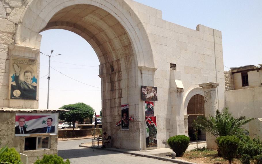 The Bab Sharki gate, a principal entrance into Damascus' walled old city. Its right pillar is adorned with posters of Christian fighters who died fighting for the government of Syria's President Bashar Assad during the seven-year civil war.