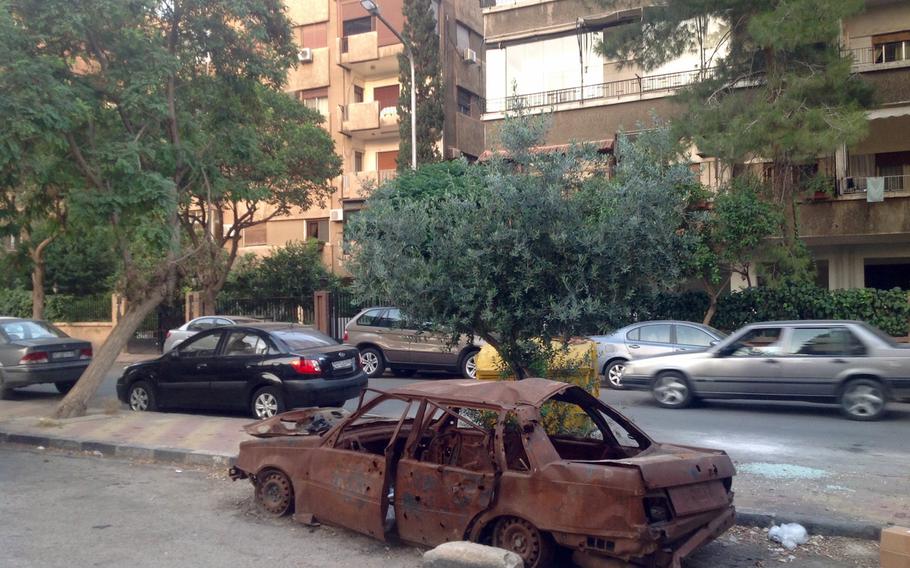 Although the war seems far away from the Syrian capital nowadays, reminders of past shellings are everywhere. This burned-out car sitting in the parking lot of a residential quarter, was hit by a mortar round in 2016.