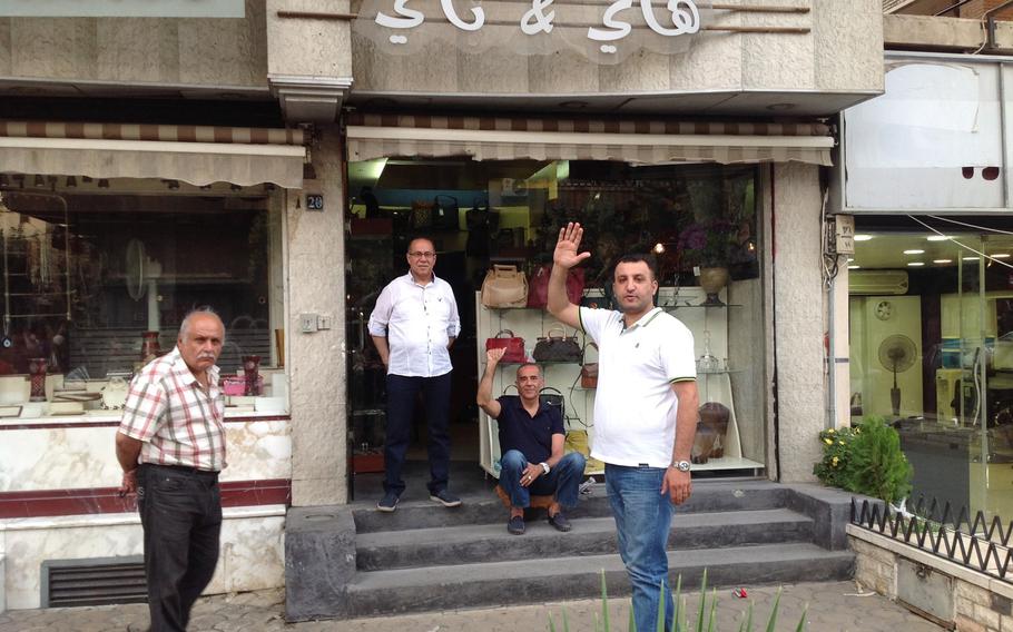 Moufit Moukabaa, seated, a jeweler from the city's eastern suburb of Jobar, said he was kidnapped and forced by the militants to turn over more than 25 pounds of gold jewelry after they took control of the district in 2012. 