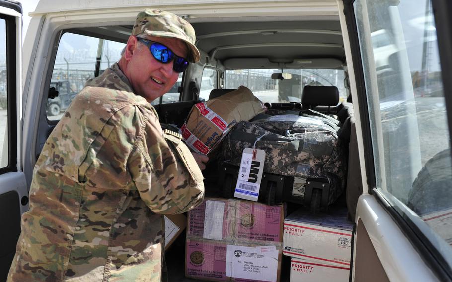 In a 2016 file photo, Eric Longenbach, a human resources specialist with the Bagram Support Group, picks up the mail as part of his additional duties. Longenbach volunteered with the Defense Department's Civilian Expeditionary Workforce to do a tour in Afghanistan. The military is struggling to convince civilians to work in Afghanistan, according to a memo issued by Defense Secretary Jim Mattis.