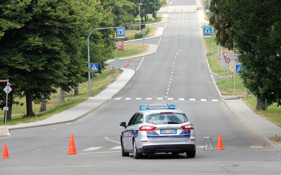 A police car guards a street on a cordoned off area near Smith Barracks on U.S. Army Garrison Baumholder on the afternoon of July 12, 2018 after a construction crew found an unexploded bomb while digging up water lines on the base.