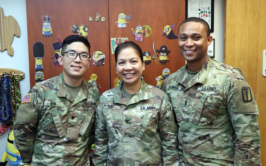 From left to right: Army Spc. Won Seok Kim, command group driver, Col. Editha Ruiz, deputy commander for nursing, and 1st Lt. Alexander Seawright, nurse, pose at the Brian Allgood Army Community Hospital in South Korea, Monday, July 16, 2018.