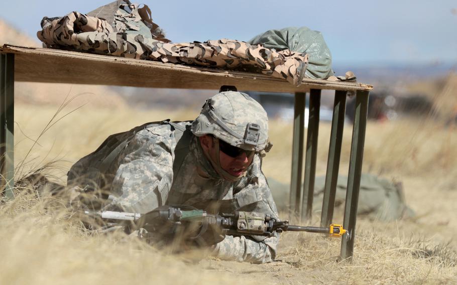 Staff Sgt. Angel Sigetti, infantry squad leader, Headquarters and Headquarters Company, 1st Battalion, 38th Infantry Regiment, 1st Stryker Brigade Combat Team, 4th Infantry Division, moves under simulated direct fire during Expert Infantryman Badge evaluations on March 15, 2016. The Army is planning to revamp evaluations for the badge.