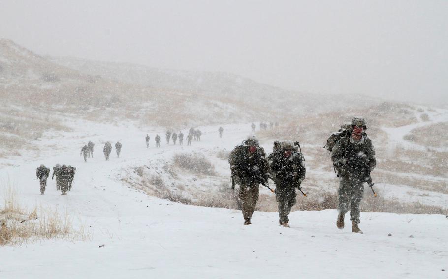Soldiers of the 4th Infantry Division march 12 miles through a snowstorm during Expert Infantryman Badge evaluations on March 18, 2016. The Army is planning to revamp evaluations for the badge.