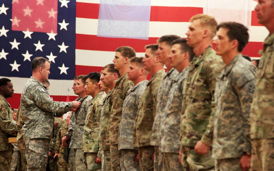 Col. Curtis D. Taylor, commander, 1st Stryker Brigade Combat Team, 4th Infantry Division, awards 33 "True Blue" soldiers with an Army Commendation Medal during an Expert Infantryman Badge ceremony on March 18, 2016. The Army is planning to revamp evaluations for the badge.
                