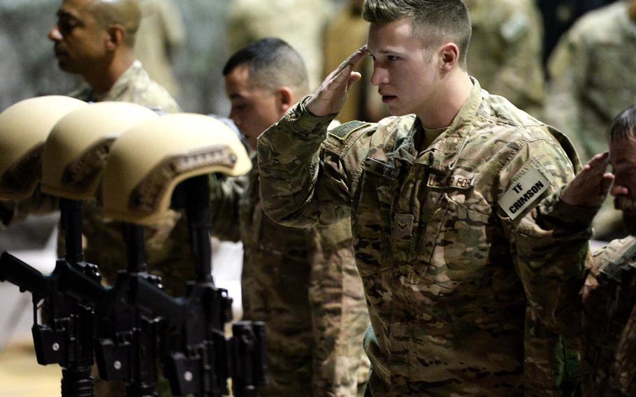 An airman salutes his fallen comrades on Wednesday, Dec. 23, 2015, at Bagram Air Field, Afghanistan, during a memorial service for six airmen killed in a suicide bombing two days earlier. One of those killed was Staff Sgt. Peter Taub. A post office in Wyncote, Pa., was renamed for Taub on Monday.
Stars and Stripes