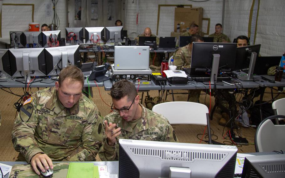 Soldiers working at exercise control at Schofield Barracks, Hawaii, administer the fight during Lightning Forge drills, Sunday, July 22, 2018.