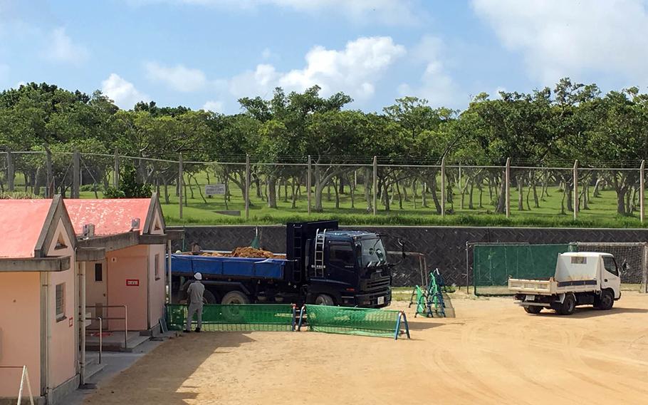 Workers construct a shelter at a Japanese elementary school adjacent to Marine Corps Air Station Futenma, Okinawa, Tuesday, July 24, 2018.