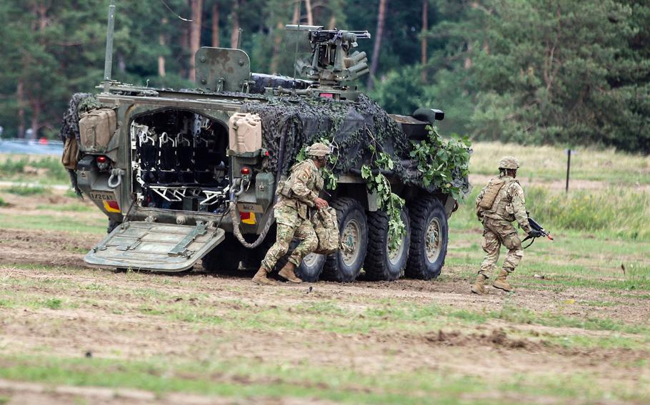U.S. Army soldiers with the 1st Squadron, 2nd Cavalry Regiment, exit a Stryker during training at Orzysz, Poland. Congress wants the Pentagon to study permanently basing soldiers in the country.