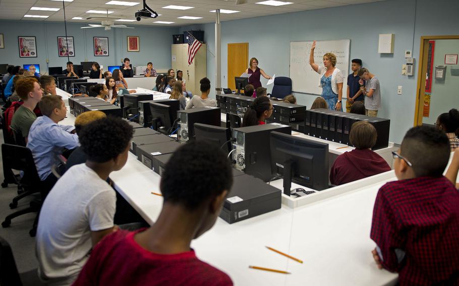Seventh-grade students receive their schedules during the first day of school at Kaiserslautern Middle School, Vogelweh, Germany, in August 2017. U.S. lawmakers are demanding that Defense Department schools do a better job of protecting students from sexual harassment and assault.