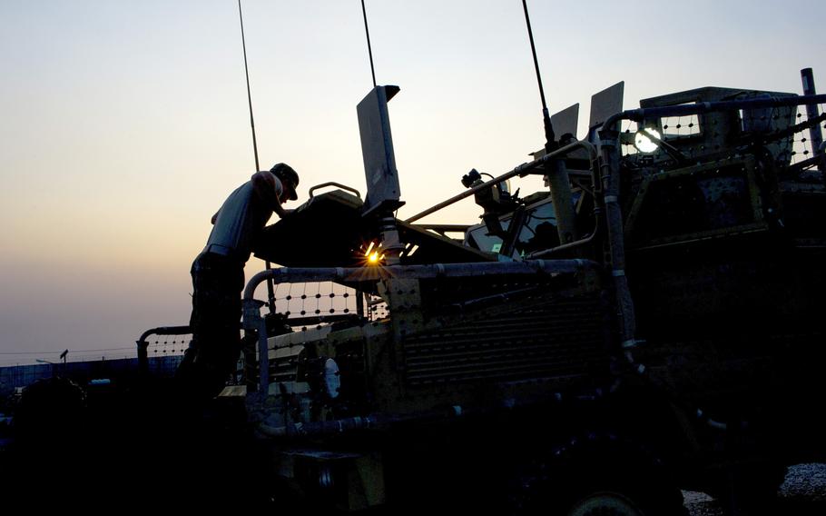 Spc. Samuel L. Esposito, 317th Brigade Engineer Battalion, 3rd Brigade Combat Team, 10th Mountain Division, closes the hood on a Mine Resistant Ambush Protected vehicle, Bagram Air Field, Afghanistan, Jan. 12, 2016. The Army doesn?t know if it got what it paid for on a contract in Afghanistan for vehicle and weapons maintenance, a Pentagon watchdog has found.