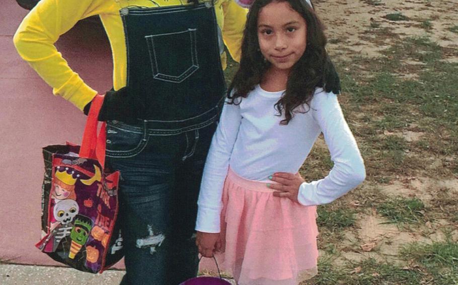 Sisters Pamela, left, and Estela Juarez trick or treat in their neighborhood in Davenport, Fla., on Halloween of 2017. The sisters and their combat veteran father are American citizens, but their mother Alejandra, who entered the U.S. illegally in 1998, is slated to be deported Friday to Mexico.
                