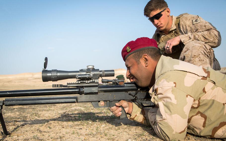 An Iraqi security forces soldier, foreground, practices trigger squeeze on a Steyr HS-50 sniper rifle under the eye of a U.S. Marine Corps scout sniper trainer during marksmanship training at Camp Manion, Iraq, March 28, 2017. NATO is sending 200 personnel to Iraq to train security forces to combat the Islamic State.