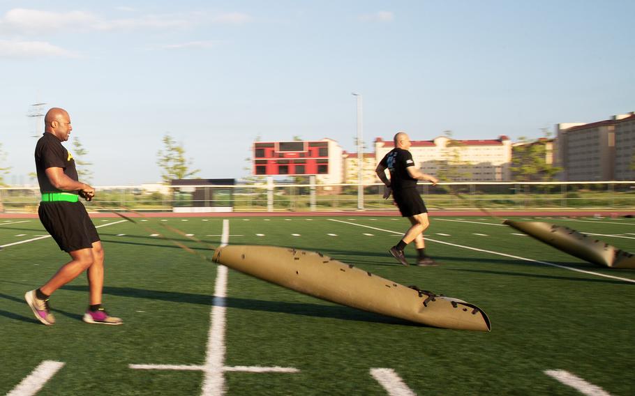 Soldiers from the 1st Armored Combat Brigade, 3rd Infantry Division pull sleds during a demo of the new Army Combat Fitness Test at Camp Humphreys, South Korea, Tuesday, July 31, 2018.