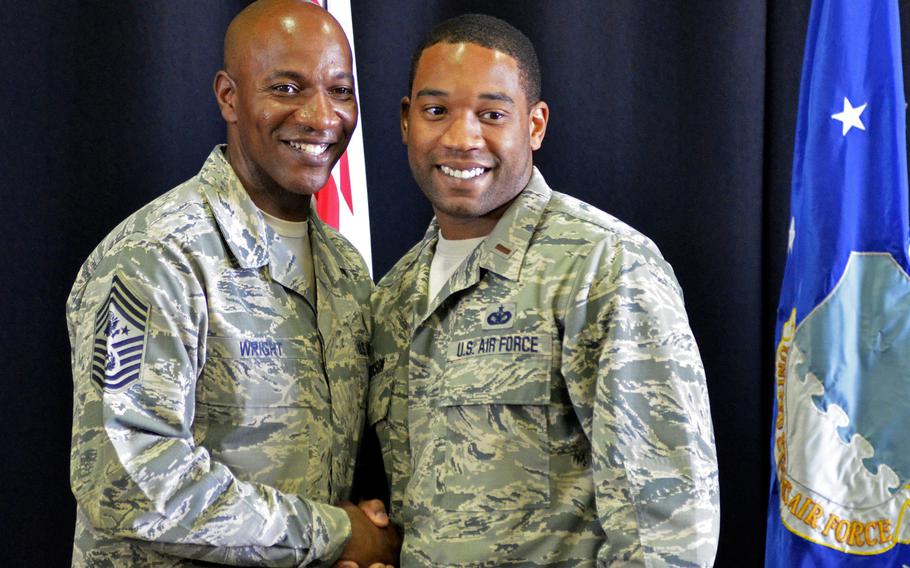 Chief Master Sergeant of the Air Force Chief Kaleth O. Wright poses for a photograph with an officer after a town hall at RAF Lakenheath, England, Wednesday, Aug. 1, 2018. More than 1000 airmen gathered to hear about coming policy changes to improve their quality of life.