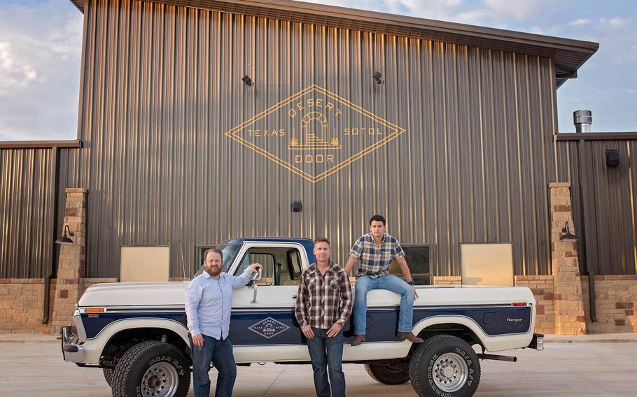 Ryan Campbell, Brent Looby and Judson Kauffman in front of the Desert Door Distillery tasting room.