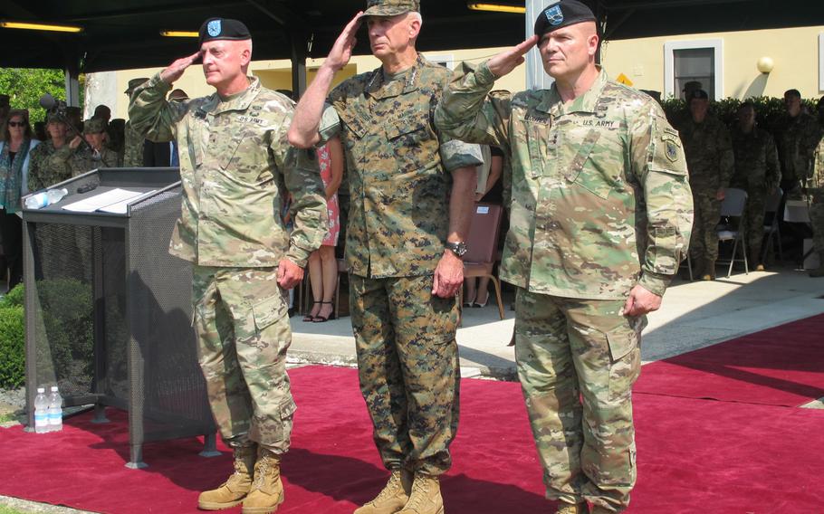 Brig. Gen. Eugene LeBoeuf, Marine Gen. Thomas Waldhauser and Maj. Gen. Roger Cloutier, from left, stand before soldiers gathered on the Caserma Ederle parade field Thursday, Aug. 3, 2018, at the start of U.S. Army Africa's change-of-command ceremony. Cloutier took over from Le Boeuf, acting commander for the past year.