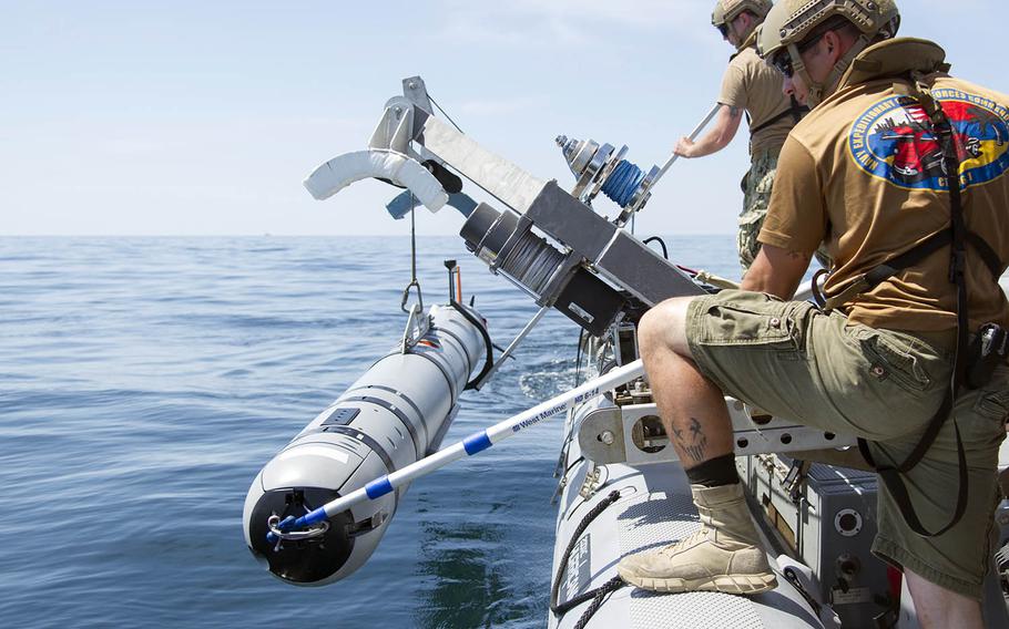 Sailors lower an unmanned underwater vehicle into the sea during a mine-countermeasures drill near Panama City, Fla., May 14, 2016.