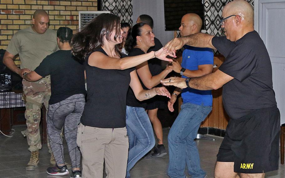 Soldiers of the Puerto Rico Army National Guard's 191st Regional Support Group Forward dance during salsa night in Kabul. Members of the Puerto Rico-based unit deployed to Afghanistan after helping those who lost everything in Hurricane Maria last fall.