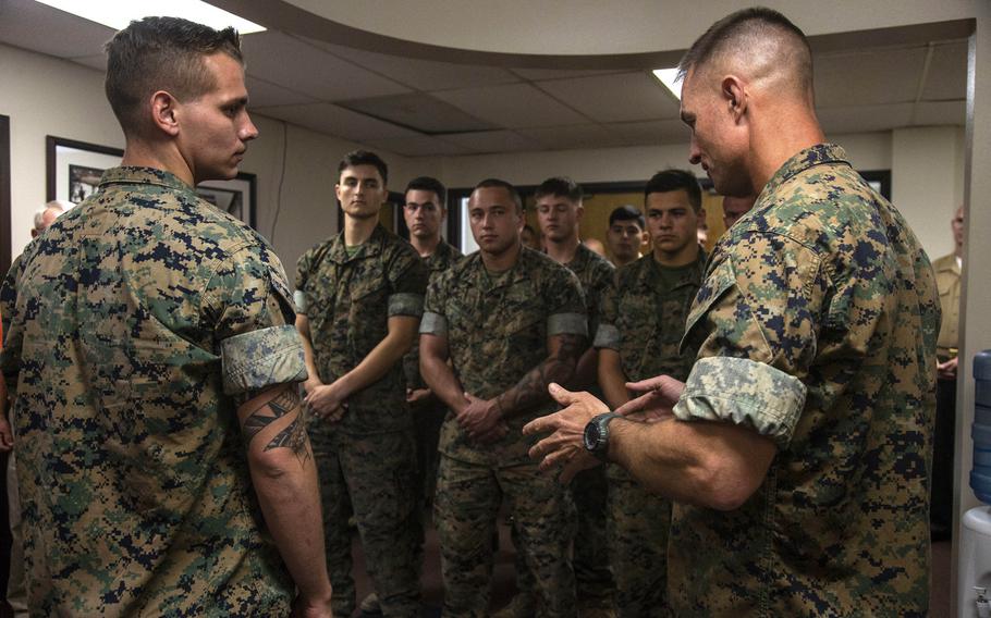 Col. Kyle B. Ellison, commanding officer of the 7th Marine Regiment, right, speaks about the actions and the esprit de corps that Lance Cpl. Dillon Bennett, machine gunner, 3rd Battalion, 7th Regiment, displayed following the presentation of a Purple Heart to Bennett at 7th Marines' Headquarters.