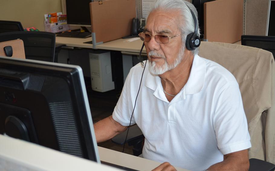 Jose Cabello, a Marine Corps veteran and call specialist with 211, answers a call at the United Way of San Antonio and Bexar County in Texas on July 6, 2018.