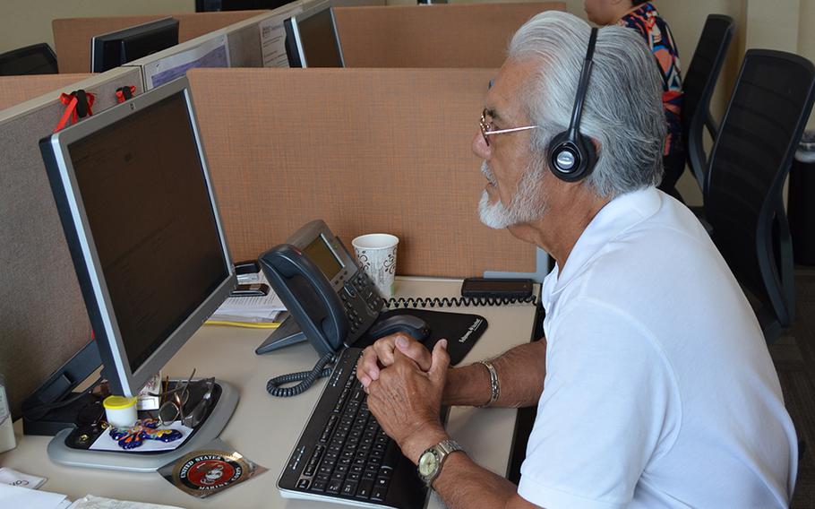 Jose Cabello, a Marine Corps veteran and call specialist with 211, answers a call at the United Way of San Antonio and Bexar County in Texas on July 6, 2018. 