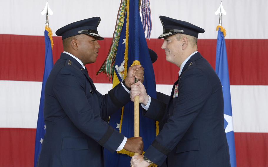 Brig. Gen. Mark R. August, right, takes the flag from Lt. Gen. Richard M. Clark, commander of 3rd Air Force, during the 86th Airlift Wing change-of-command ceremony at Ramstein Air Base, Germany, Thursday, Aug. 9, 2018. August took over command from Brig. Gen. Richard G. Moore Jr.