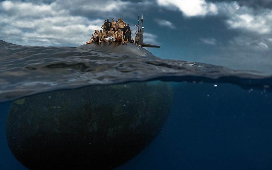 Submariners from the Pearl Harbor-based USS Olympia participate in a swim call in the Pacific Ocean, July 31, 2018.