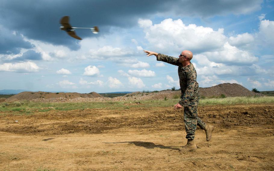 A U.S. Marine with Black Sea Rotational Force launches a RQ-12 Wasp, small unmanned aerial system, into the air during Exercise Platinum Lion 18 at Novo Selo Training Area, Bulgaria, July 31, 2018.