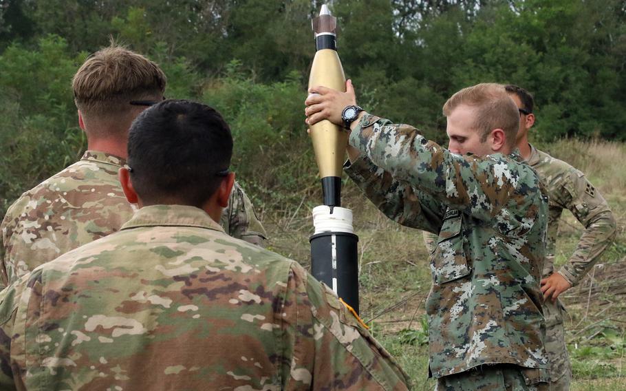 Soldiers with the 61st Cavalry Regiment observe a Macedonian soldier firing a 120 mm mortar at the Krivolak Training Area in Macedonia, Aug. 3, 2018.