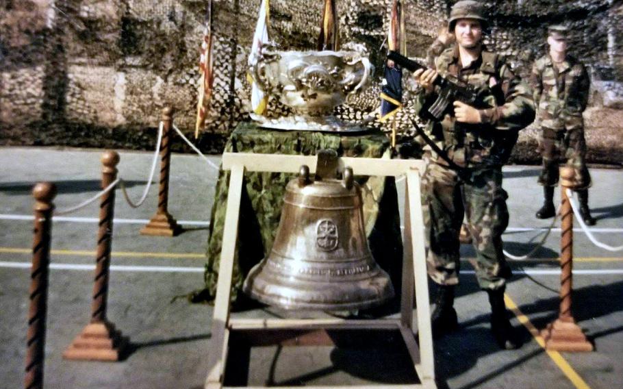One of the controversial Bells of Balangiga, bells seized in the aftermath of a battle during the Philippine-American War, now resides in South Korea, where Michael Stender, then an infantryman with the 1st Battalion, 9th Infantry Regiment headquarters posed with the bell in 1996.