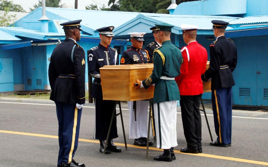 United Nations Command troops prepare to hand over the remains of a North Korean soldier in the truce village of Panmunjom, Tuesday, Aug. 14, 2018.
