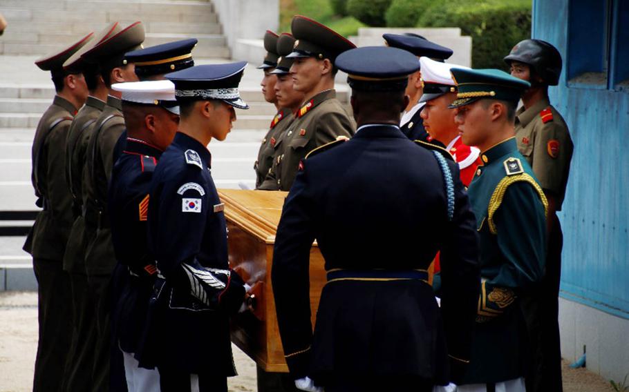 United Nations Command troops hand over the remains of a North Korean soldier in the truce village of Panmunjom, Tuesday, Aug. 14, 2018.