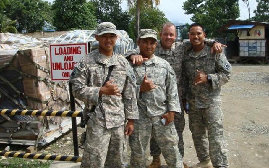 Staff Sgt. Reymund Rarogal Transfiguracion, 36, second from left, died from injuries sustained when a roadside bomb detonated near him while he was on patrol in Afghanistan's Helmand province. Transfiguracion had always dreamed of becoming a Green Beret, family members said. 
                