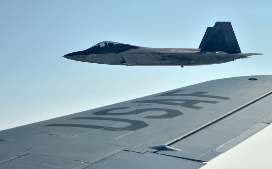 A U.S. Air Force F-22 Raptor of the 325th Fighter Wing flies off the wing of a KC-135 Stratotanker of the 100th Air Refueling Wing after taking on fuel on its way to Norway, Wednesday, Aug. 15, 2018. Two Raptors were joined in the air by two Norwegian air force F-35s.