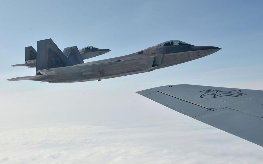 Two U.S. Air Force F-22 Raptors of the 325th Fighter Wing fly off the wing of a KC-135 Stratotanker of the 100th Air Refueling Wing after taking on fuel on their way to Norway, Wednesday, Aug. 15, 2018. Two Raptors were joined in the air by two Norwegian air force F-35s.