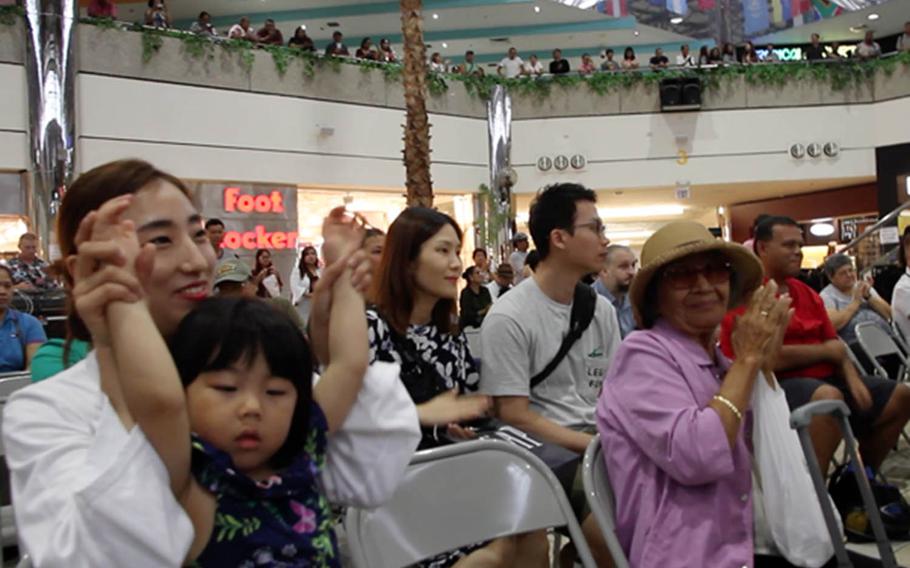 The crowd cheers for the Okinawa-based III Marine Expeditionary Force Band during a performance late last month on Guam.