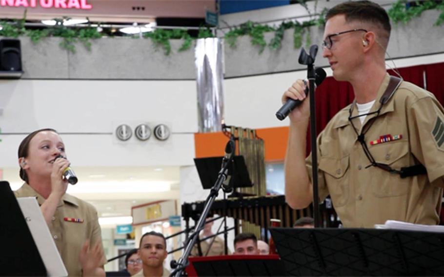 Lance Cpl. Jessica Wright and Sgt. Ivan Arden of the III Marine Expeditionary Force Band sing a duet during a performance last month on Guam.