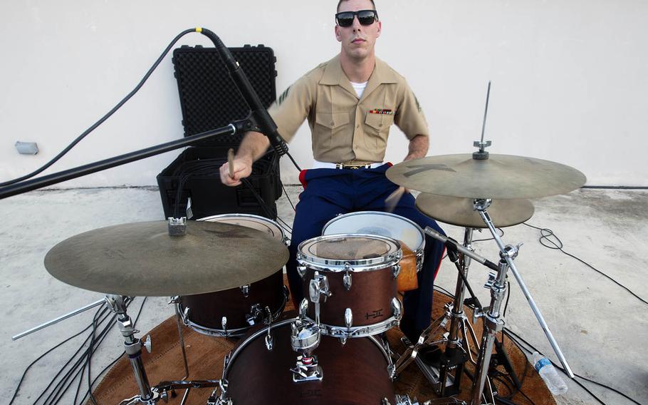 A member of the Okinawa-based III Marine Expeditionary Force Band performs a solo during a concert late last month on Guam.