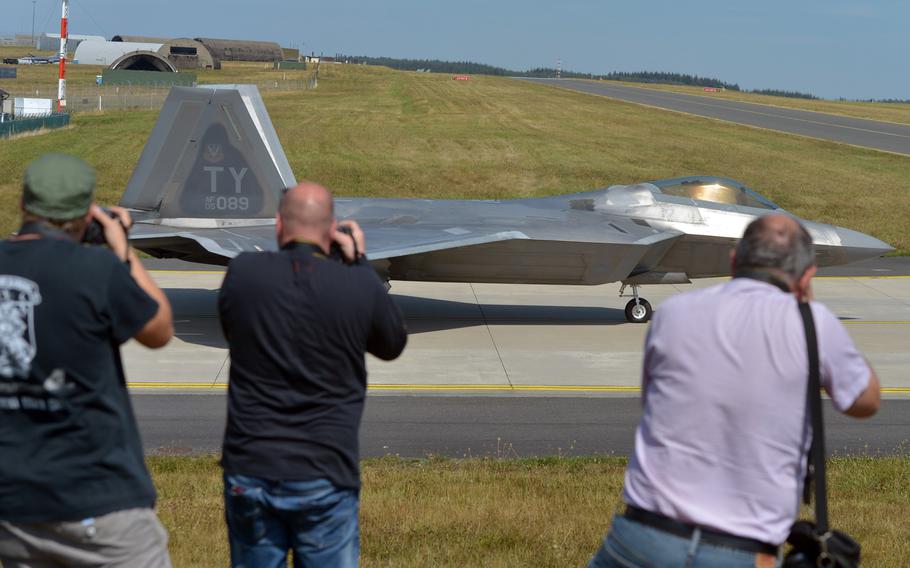 A group of international photographers aim their cameras at a F-22 Raptor of the 95th Fighter Squadron from Tyndall Air Force Base, Florida, as it taxis out for takeoff. Thirteen F-22s are forward deployed to Spangdahlem at the moment.