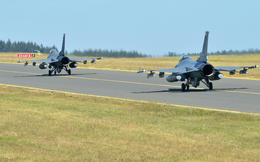 A pair of F-16 Fighting Falcons of the 480th Fighter Squadron roll down the taxiway at Spangdahlem Air Base, Germany, Thursday, Aug. 16, 2018.
