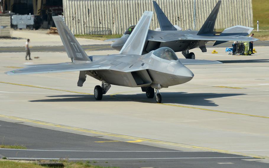Two F-22 Raptors from the 95th Fighter Squadron start taxing toward the runway for takeoff from Spangdahlem Air Base, Germany. Based at Tyndall Air Force Base, Fla., the aircraft are forward deployed to Europe for training.