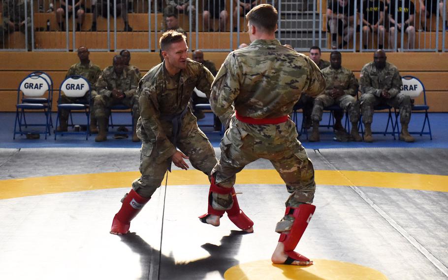 Lt. Zachary Bregovi, right, lands a leg kick against Lt. Robert Martin during the 2018 U.S. Army Europe Best Warrior Competition, at Grafenwoehr, Germany, Friday, Aug. 17, 2018.