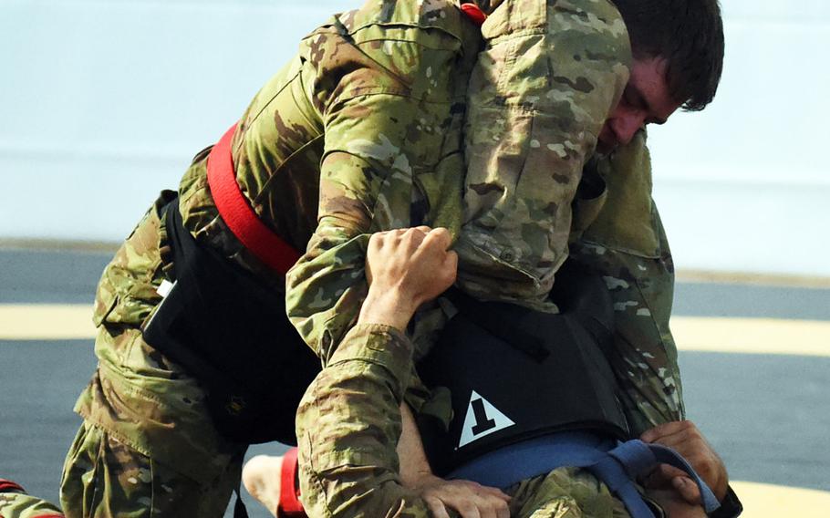 Spc. Piotr Drwal, bottom right, goes for a triangle choke against Pfc. Christopher Kop, at the 2018 U.S. Army Europe Best Warrior Competition, Friday, Aug. 17, 2018, at Grafenwoehr, Germany.