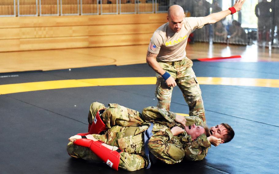 Spc. Derek Teegardin, right, uses a rear-naked choke against Spc. Robert Dees at the 2018 U.S. Army Europe Best Warrior Competition, Friday, Aug. 17, 2018, at Grafenwoehr, Germany.