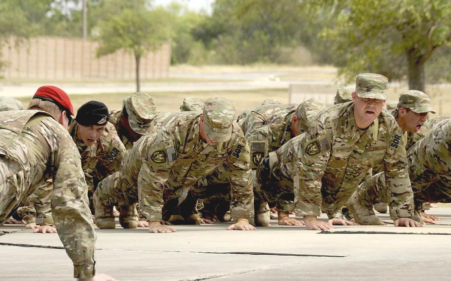 As part of the unit's activation ceremony June 29, members of the 330th Recruiting Squadron perform memorial push-ups at the Lt. Col. William Schroeder memorial, Joint Base San Antonio-Lackland Medina Annex in Texas. The 330th is the first specialized Air Force Special Operations recruiting squadron.