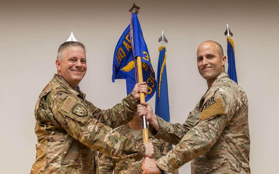 U.S. Air Force Col. Robert Trayers, Headquarters Air Force Recruiting Service vice commander, passes the 330th Recruiting Squadron guidon to Maj. Heath Kerns during the June 29 activation and assumption of command ceremony at Joint Base San Antonio-Medina Annex. Their mission is to train and assess the next generation of Air Force Special Operations and combat support forces.