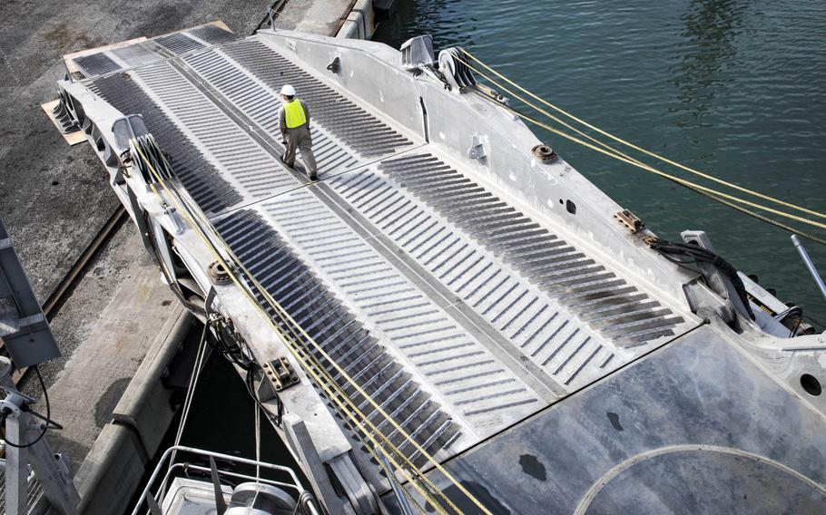 Civil service mariner 3rd Mate Christian Fitzgerald walks down the stern ramp of the expeditionary fast transport ship USNS Carson City in Poti, Georgia, Wednesday, Aug. 22, 2018.