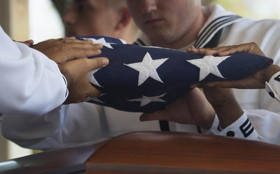 Navy Region Hawaii sailors fold a flag during the funeral of Petty Officer 1st Class Arthur Glenn, who died aboard the USS Oklahoma during the Pearl Harbor attack, at the National Memorial Cemetery of the Pacific, Hawaii, Aug. 21, 2018.